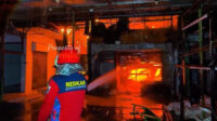 Petugas pemadam kebakaran berupaya memadamkan kobaran api yang melanda kawasan permukiman padat di Kemayoran, Jakarta Pusat
