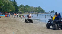 Wisatawan menikmati suasana pantai di kawasan Anyer-Cinangka, Kabupaten Serang, saat libur panjang